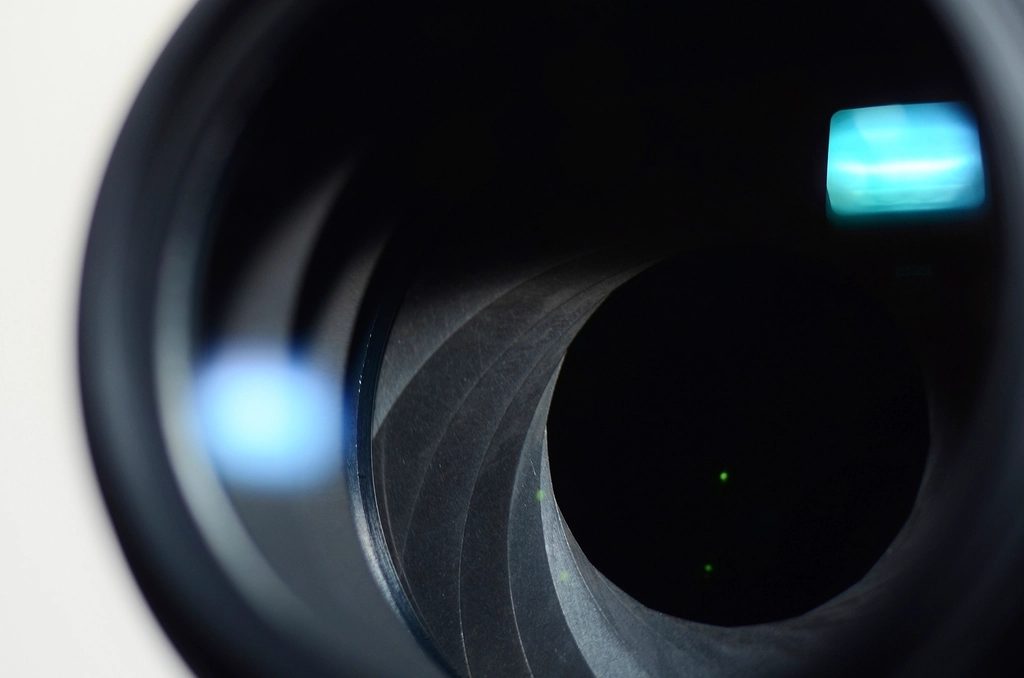 The iris blades of a lens, wide open, photographed down the barrel