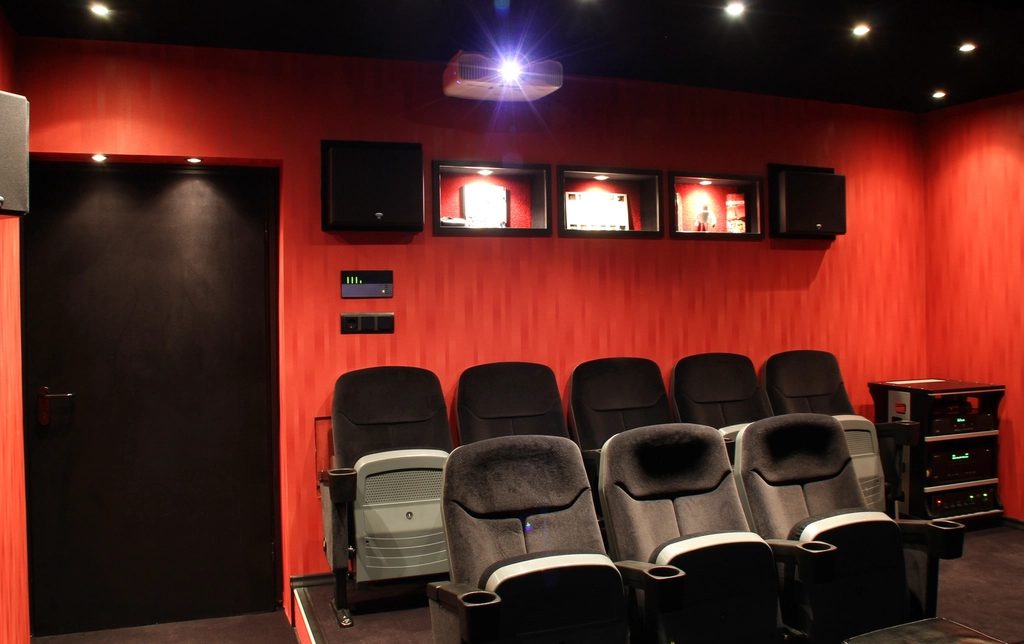 A darkened auditorium, seats facing the screen