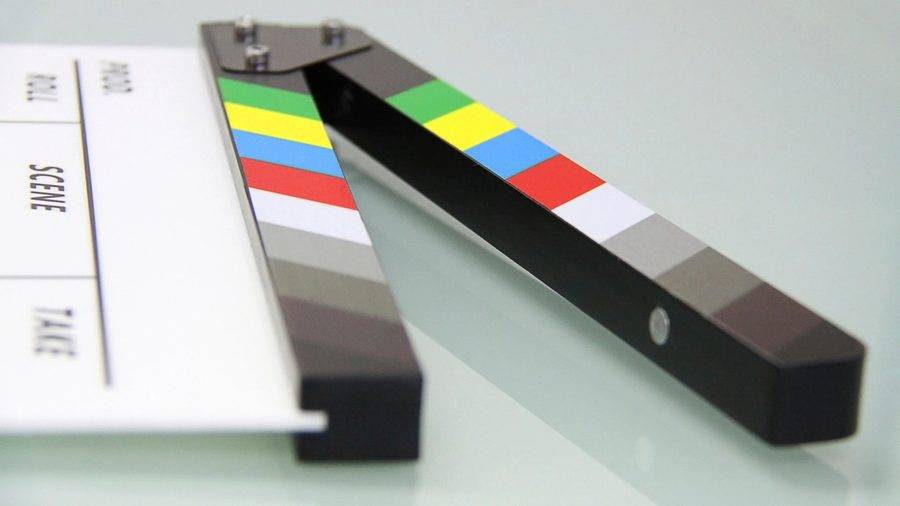 A clapperboard with a colour chart along its edge