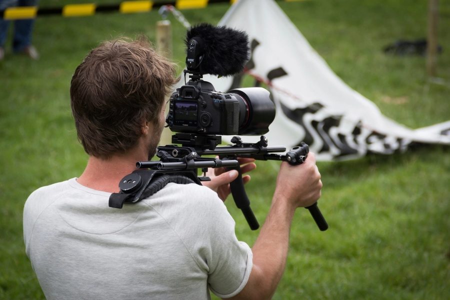 A camera operator working handheld with a shoulder rig